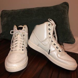 All white high top Nike sneakers